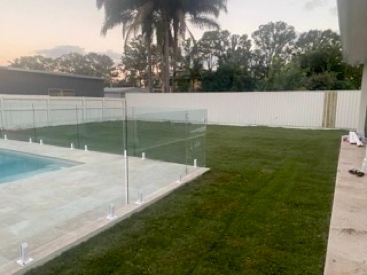 Poolside turf against glass fencing