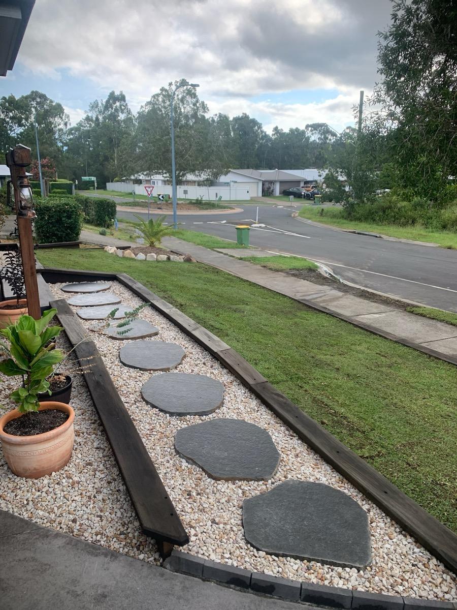 Front garden with stepping stones and planters